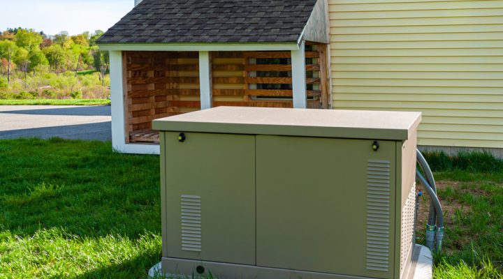 residential standby generator at the side of a house