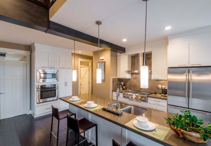 Modern, bright, clean, kitchen interior with stainless steel appliances in a luxury house
